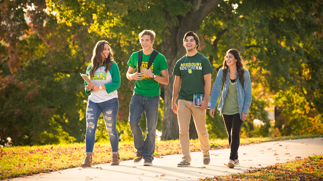 A group of students walking through campus
